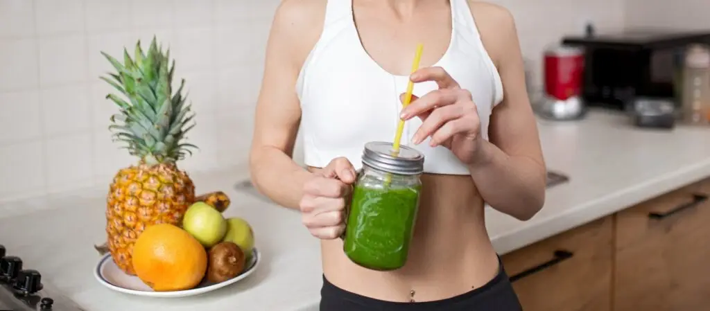 Optimistic sportswoman enjoying healthy drink